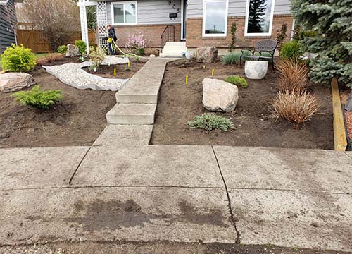 Front yard of a house in the middle of new landscaping being done.